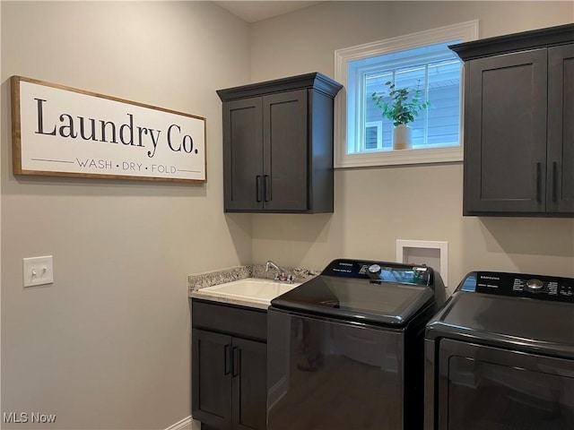 washroom featuring washer and dryer, cabinet space, and baseboards