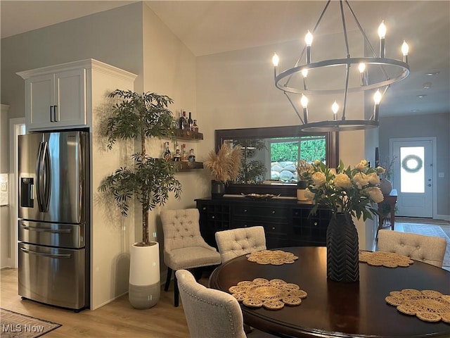 7892 Fox Hunter Ln, Concord, OH 44077 - dining area featuring a chandelier, light wood-type flooring, and baseboards