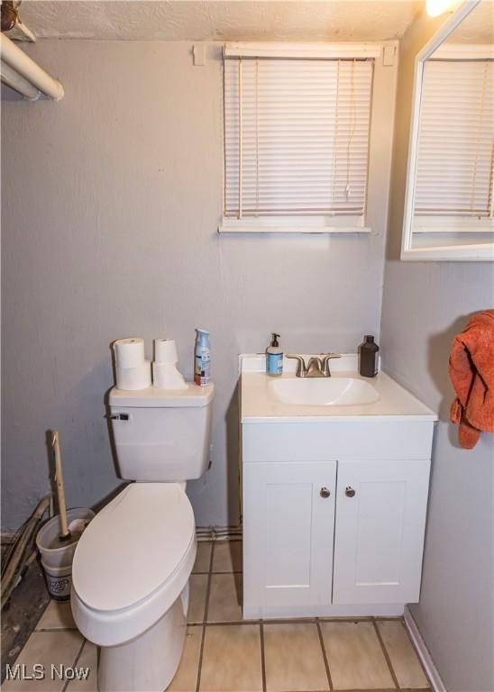 4697-4701 Maple Spur Dr, Stow, OH 44224 - half bath featuring vanity, tile patterned floors, and toilet
