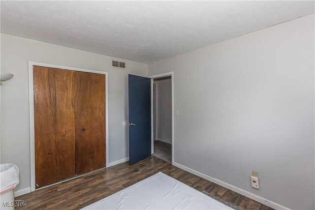 4697-4701 Maple Spur Dr, Stow, OH 44224 - unfurnished bedroom featuring wood finished floors, a closet, baseboards, and a textured ceiling