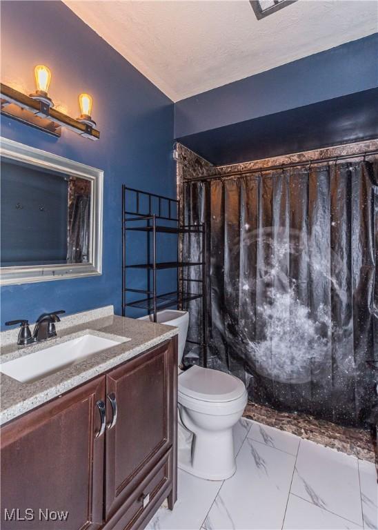 4697-4701 Maple Spur Dr, Stow, OH 44224 - full bath with marble finish floors, toilet, and vanity
