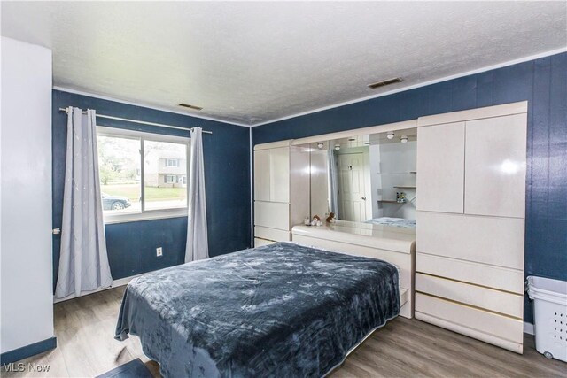 4697-4701 Maple Spur Dr, Stow, OH 44224 - bedroom with wood finished floors, a textured ceiling, and baseboards