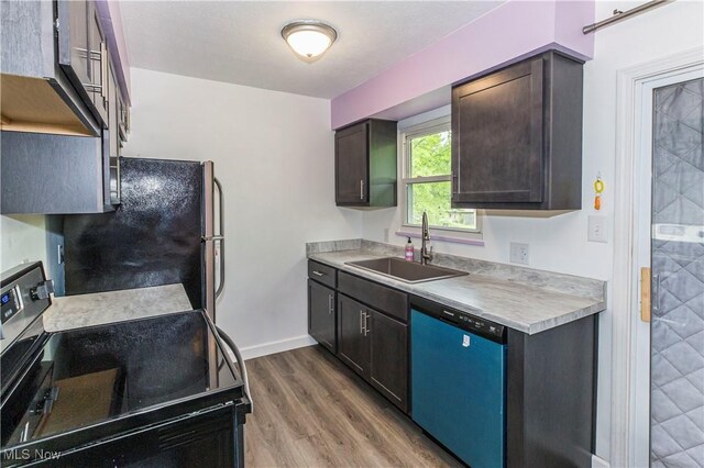 4697-4701 Maple Spur Dr, Stow, OH 44224 - kitchen featuring appliances with stainless steel finishes, a sink, light countertops, wood finished floors, and dark brown cabinets