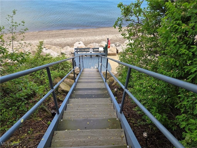 surrounding community featuring view of water and beach