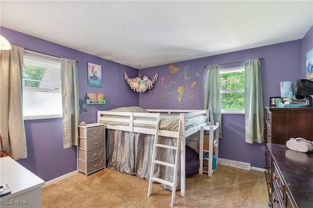 bedroom with carpet floors and baseboards