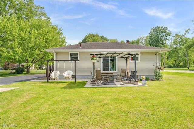 back of property featuring a pergola, a lawn, a patio area, and a chimney