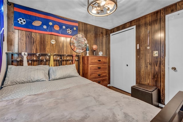 3226 Woodlawn Dr, Parma, OH 44134 - bedroom with a chandelier, wooden walls, and a closet