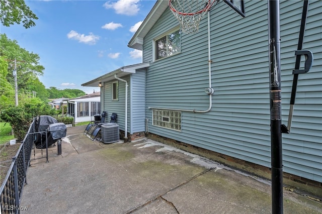 3226 Woodlawn Dr, Parma, OH 44134 - view of patio featuring a sunroom, central AC unit, and area for grilling