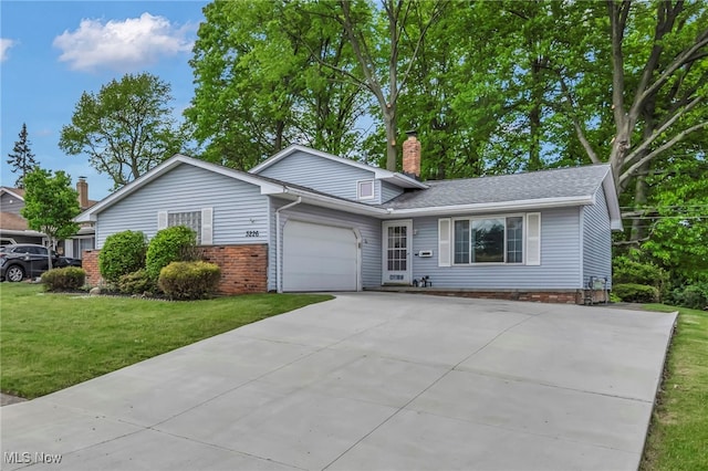 3226 Woodlawn Dr, Parma, OH 44134 - view of front of house featuring concrete driveway, a garage, a chimney, a front lawn, and brick siding