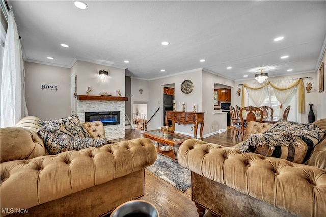 3226 Woodlawn Dr, Parma, OH 44134 - living room featuring recessed lighting, wood finished floors, ornamental molding, and a stone fireplace