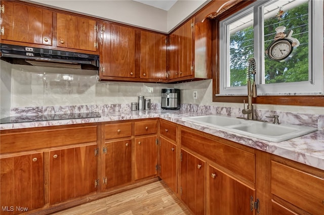 3226 Woodlawn Dr, Parma, OH 44134 - kitchen with a sink, light countertops, black electric stovetop, and brown cabinetry