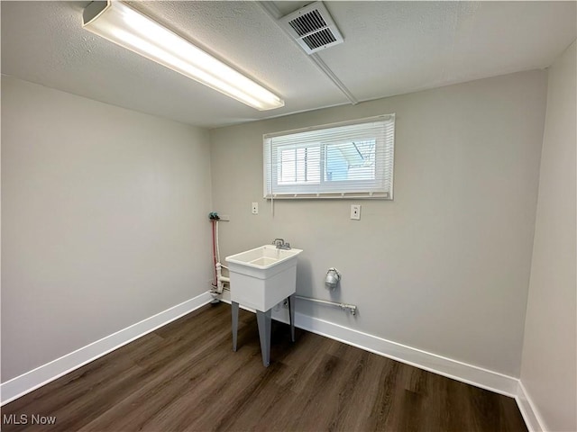1400 Yale Dr, Brunswick, OH 44212 - laundry room with dark wood-style flooring, baseboards, and a textured ceiling