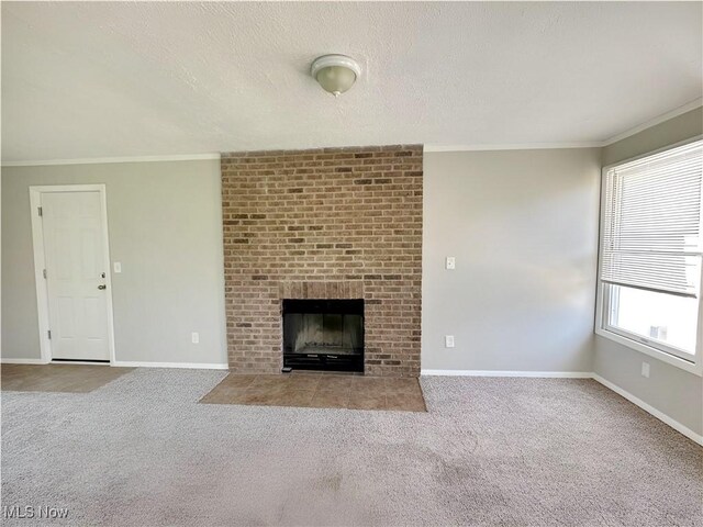 1400 Yale Dr, Brunswick, OH 44212 - unfurnished living room with carpet floors, ornamental molding, baseboards, a brick fireplace, and a textured ceiling