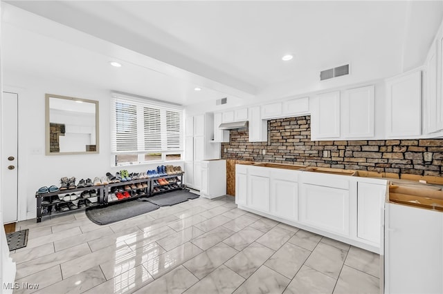 6395 Easton St NE, Louisville, OH 44641 - kitchen with decorative backsplash, white cabinets, under cabinet range hood, and recessed lighting