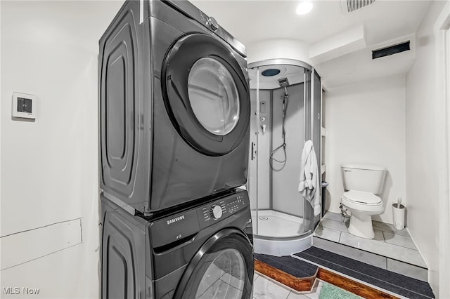 6395 Easton St NE, Louisville, OH 44641 - clothes washing area featuring stacked washer / drying machine and tile patterned floors