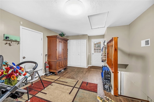 6395 Easton St NE, Louisville, OH 44641 - playroom featuring attic access, wood finished floors, baseboards, and a textured ceiling