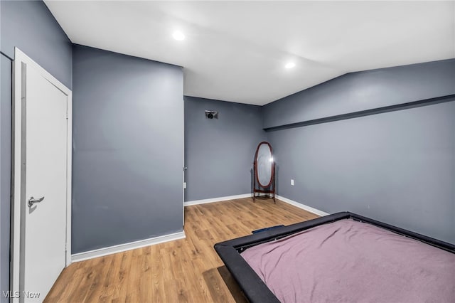 6395 Easton St NE, Louisville, OH 44641 - unfurnished bedroom with wood finished floors, recessed lighting, and baseboards