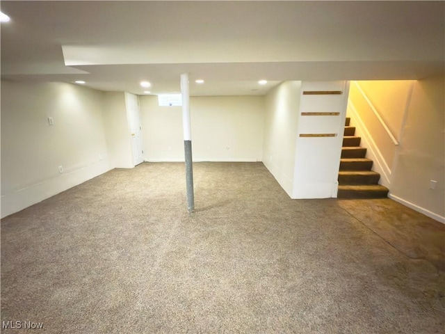 finished below grade area featuring stairs, carpet, recessed lighting, and baseboards