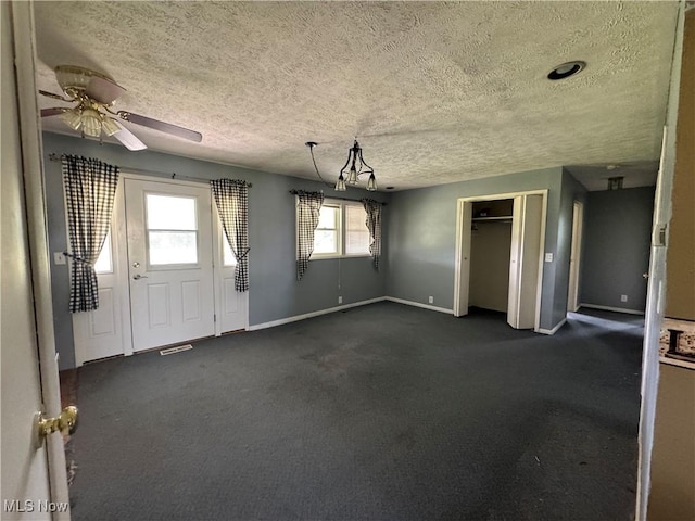 61272 Salem Rd, Salesville, OH 43778 - unfurnished dining area with a textured ceiling, baseboards, ceiling fan, and dark colored carpet