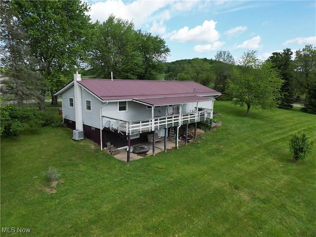 61272 Salem Rd, Salesville, OH 43778 - back of house featuring a yard, a wooden deck, a chimney, and metal roof