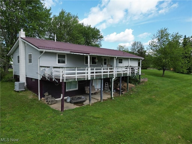 61272 Salem Rd, Salesville, OH 43778 - rear view of house featuring a chimney, a lawn, central AC unit, a patio, and metal roof