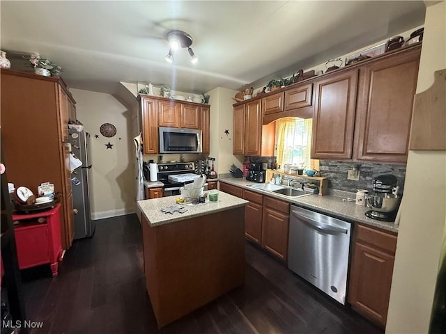 1710 Clairmont Ave, Cambridge, OH 43725 - kitchen featuring appliances with stainless steel finishes, a sink, dark wood-style floors, and decorative backsplash