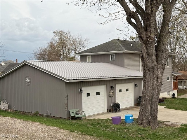 1710 Clairmont Ave, Cambridge, OH 43725 - view of home's exterior with metal roof, an attached garage, and concrete driveway