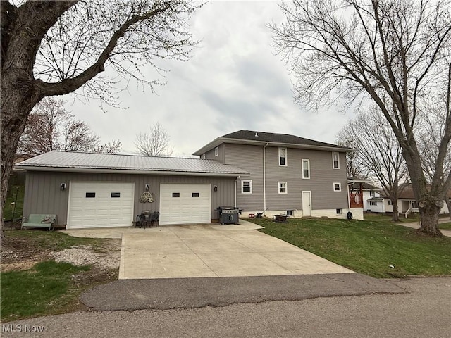 1710 Clairmont Ave, Cambridge, OH 43725 - view of home's exterior featuring an attached garage, concrete driveway, board and batten siding, metal roof, and a yard