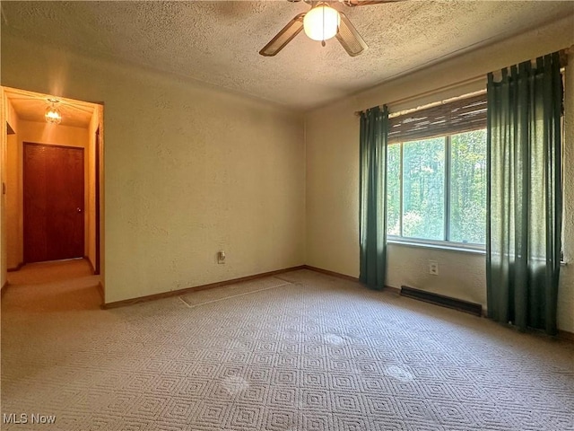 1010 Park Cir, Girard, OH 44420 - empty room featuring a textured ceiling, a ceiling fan, light colored carpet, and a textured wall