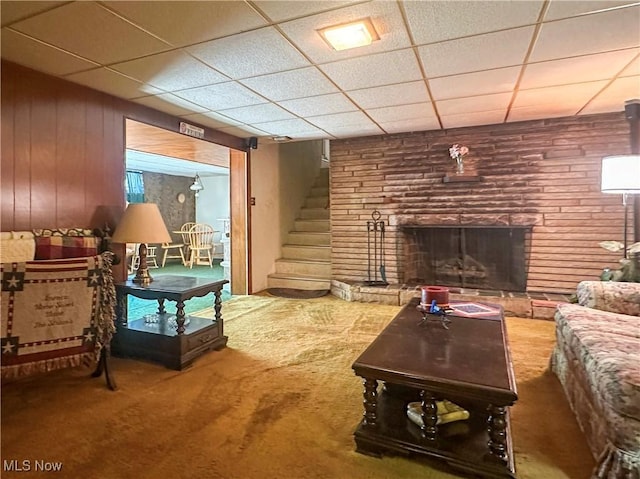 1010 Park Cir, Girard, OH 44420 - carpeted living room with stairs, a paneled ceiling, and a fireplace