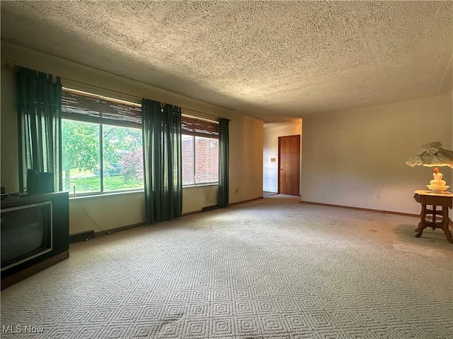 1010 Park Cir, Girard, OH 44420 - empty room featuring a textured ceiling, carpet floors, and baseboards