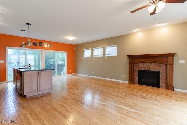 3602 Marvin Ave, Cleveland, OH 44109 - kitchen with light wood-style floors, dark countertops, a ceiling fan, and hanging light fixtures