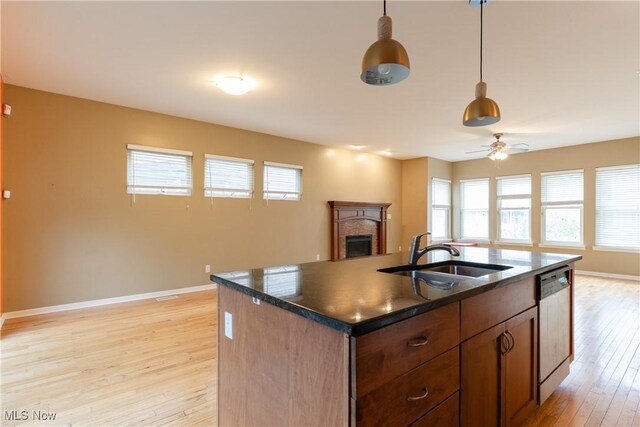 3602 Marvin Ave, Cleveland, OH 44109 - kitchen featuring a sink, dishwasher, a fireplace, dark countertops, and open floor plan