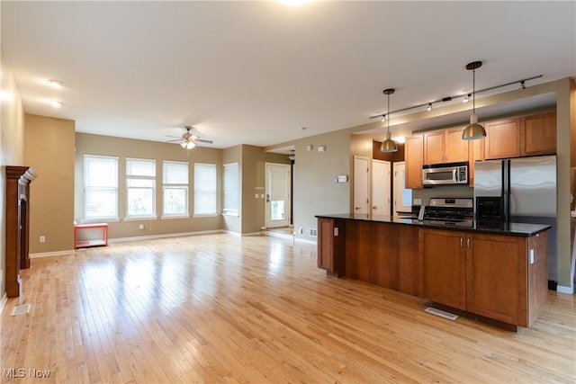 3602 Marvin Ave, Cleveland, OH 44109 - kitchen featuring stainless steel appliances, a ceiling fan, dark countertops, light wood finished floors, and baseboards