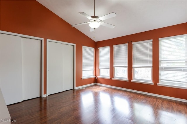 3602 Marvin Ave, Cleveland, OH 44109 - unfurnished bedroom with vaulted ceiling, multiple closets, wood finished floors, and multiple windows