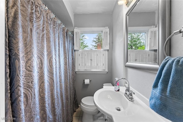 79 Leighton Ave, Youngstown, OH 44512 - bathroom featuring a sink, healthy amount of natural light, tile patterned floors, and toilet