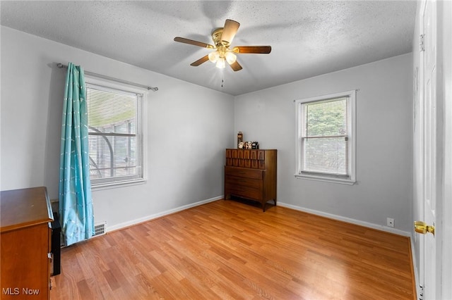 79 Leighton Ave, Youngstown, OH 44512 - bedroom with light wood finished floors, baseboards, ceiling fan, and a textured ceiling