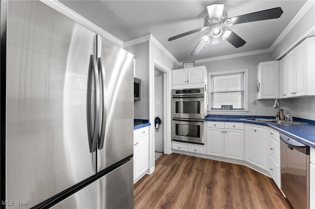 79 Leighton Ave, Youngstown, OH 44512 - kitchen with appliances with stainless steel finishes, a sink, dark wood finished floors, ornamental molding, and white cabinets