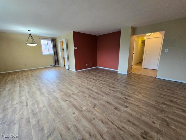 16100 Van Aken Blvd, Shaker Heights, OH 44120 - unfurnished living room featuring wood finished floors and baseboards