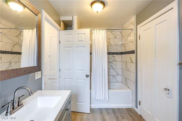 bathroom featuring shower / bath combo with shower curtain, wood finished floors, and vanity