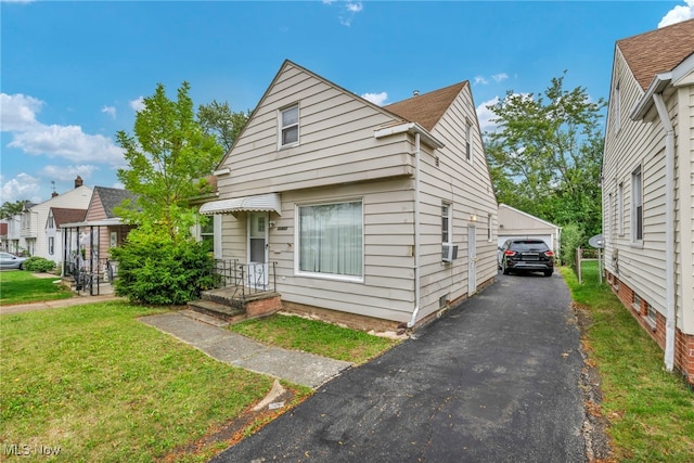 21407 Libby Rd, Maple Heights, OH 44137 - view of front of home featuring a front lawn, a garage, an outdoor structure, and cooling unit