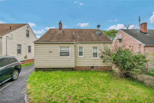 21407 Libby Rd, Maple Heights, OH 44137 - rear view of property featuring a lawn and a chimney