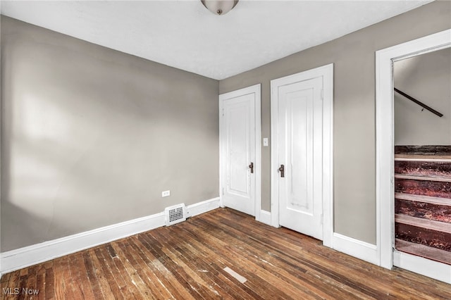 955 Dresden Rd, Cleveland Heights, OH 44112 - unfurnished bedroom with baseboards and dark wood-style floors