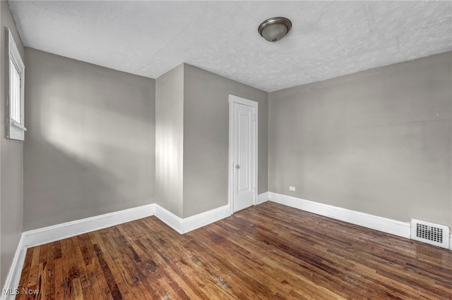 955 Dresden Rd, Cleveland Heights, OH 44112 - unfurnished room with baseboards, wood-type flooring, and a textured ceiling