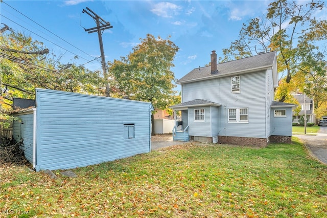 955 Dresden Rd, Cleveland Heights, OH 44112 - rear view of property featuring a yard, a chimney, and an outbuilding
