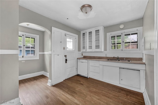 955 Dresden Rd, Cleveland Heights, OH 44112 - kitchen with a sink, dishwasher, arched walkways, white cabinets, and dark wood finished floors