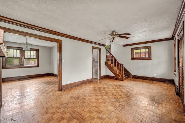 955 Dresden Rd, Cleveland Heights, OH 44112 - unfurnished living room with baseboards, a textured ceiling, a chandelier, healthy amount of natural light, and ornamental molding