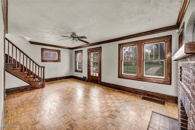 955 Dresden Rd, Cleveland Heights, OH 44112 - unfurnished living room with baseboards, ceiling fan, a textured ceiling, stairs, and ornamental molding