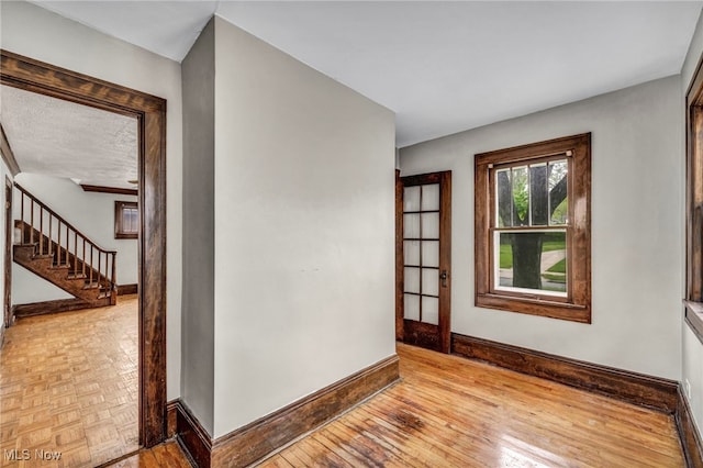 955 Dresden Rd, Cleveland Heights, OH 44112 - spare room featuring baseboards, stairway, and wood finished floors