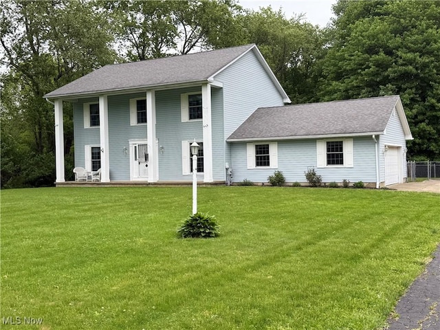 neoclassical / greek revival house with covered porch, a shingled roof, and a front yard
